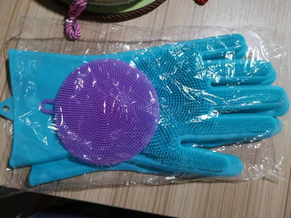 Pair of gloves together with the scrubber packaged the way you will receive them.